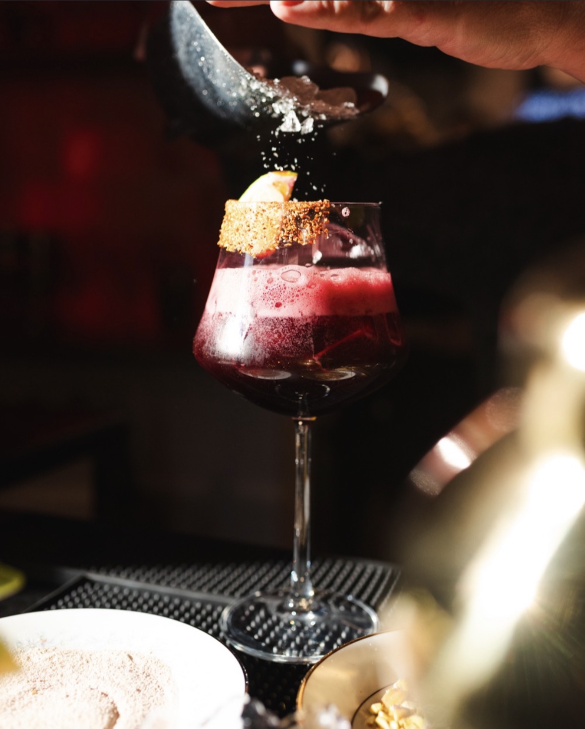Signature craft cocktail being finished at the bar